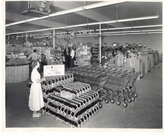 1957 Lamb's Thriftway grand opening. Forrest Lamb stands at first checkout register.
