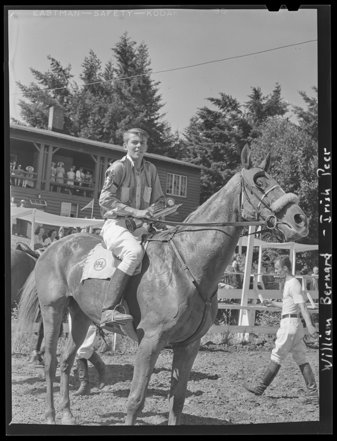 1940-06-15 Hunt Club William Bernard sits atop Irish Peer at the spring race meet for the Portland Hunt Club, in Garden home. He is holding a trophy and ribbon in one hand