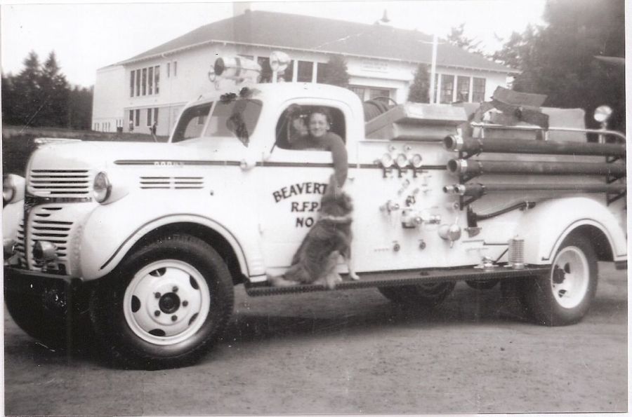 1950s Jean Johnson and dog Billy Boy at Garden Home Garage. Truck is local Volunteer Beaverton Fire Department.