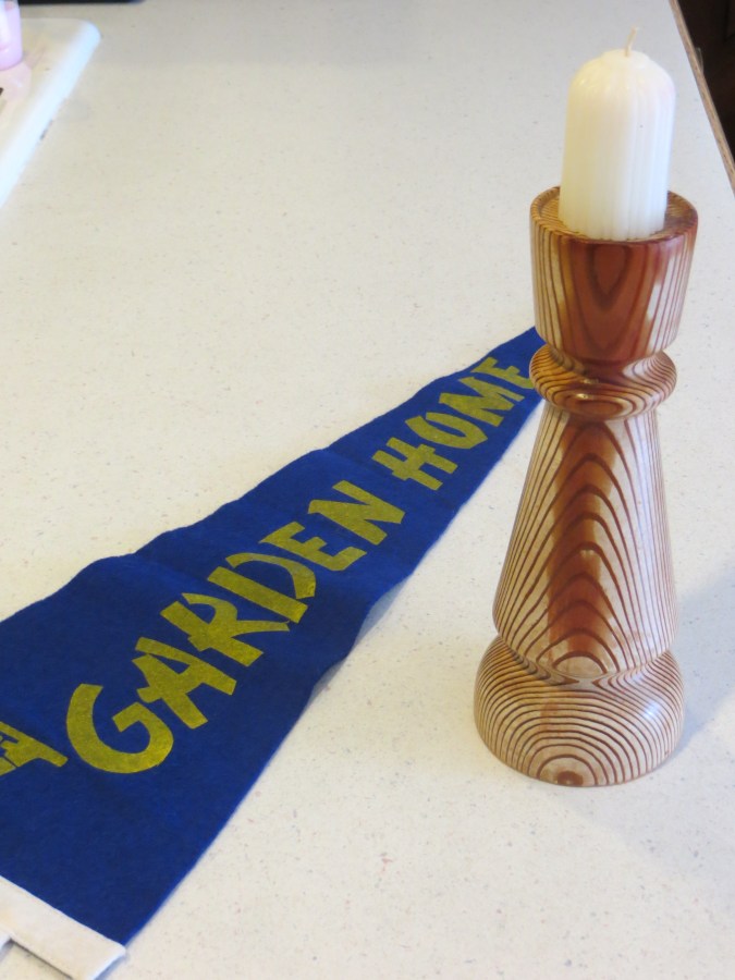 Old pennant and a candlestick made of wood from original Garden Home School