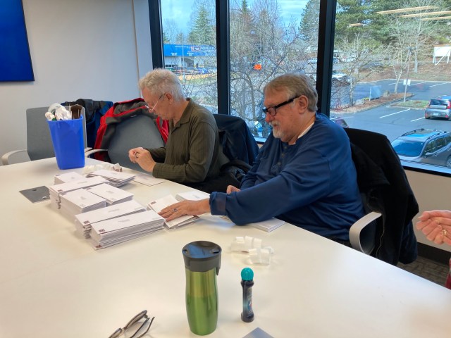 Jan Fredrickson and Kevin Mistler stamping the mailer
