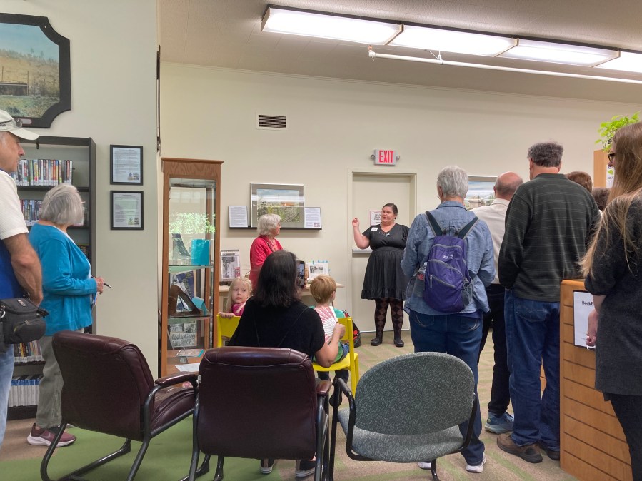 Library Director Molly Carlisle greets the audience